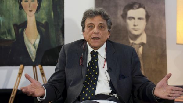 Gennaro Arbia, el abogado del dueño cuyo nombre se desconoce, junto a la pintura y un retrato del artista (AP)
