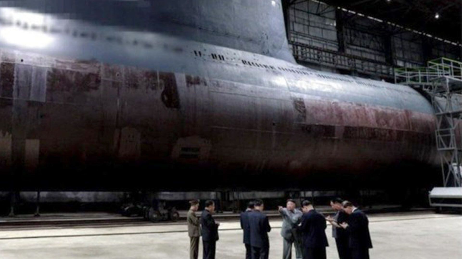 Kim Jong-un visita el astillero Shinpo. Detrás de él, lo que se cree podría ser el nuevo submarino de Corea del Norte (CSIS/Airbus)