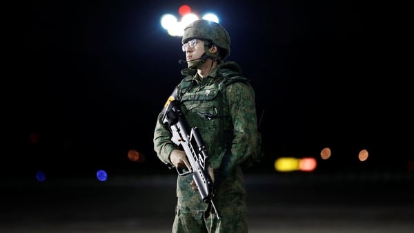 Un soldado custodia la pista de aterrizaje durante la llegada de Trump (Reuters)