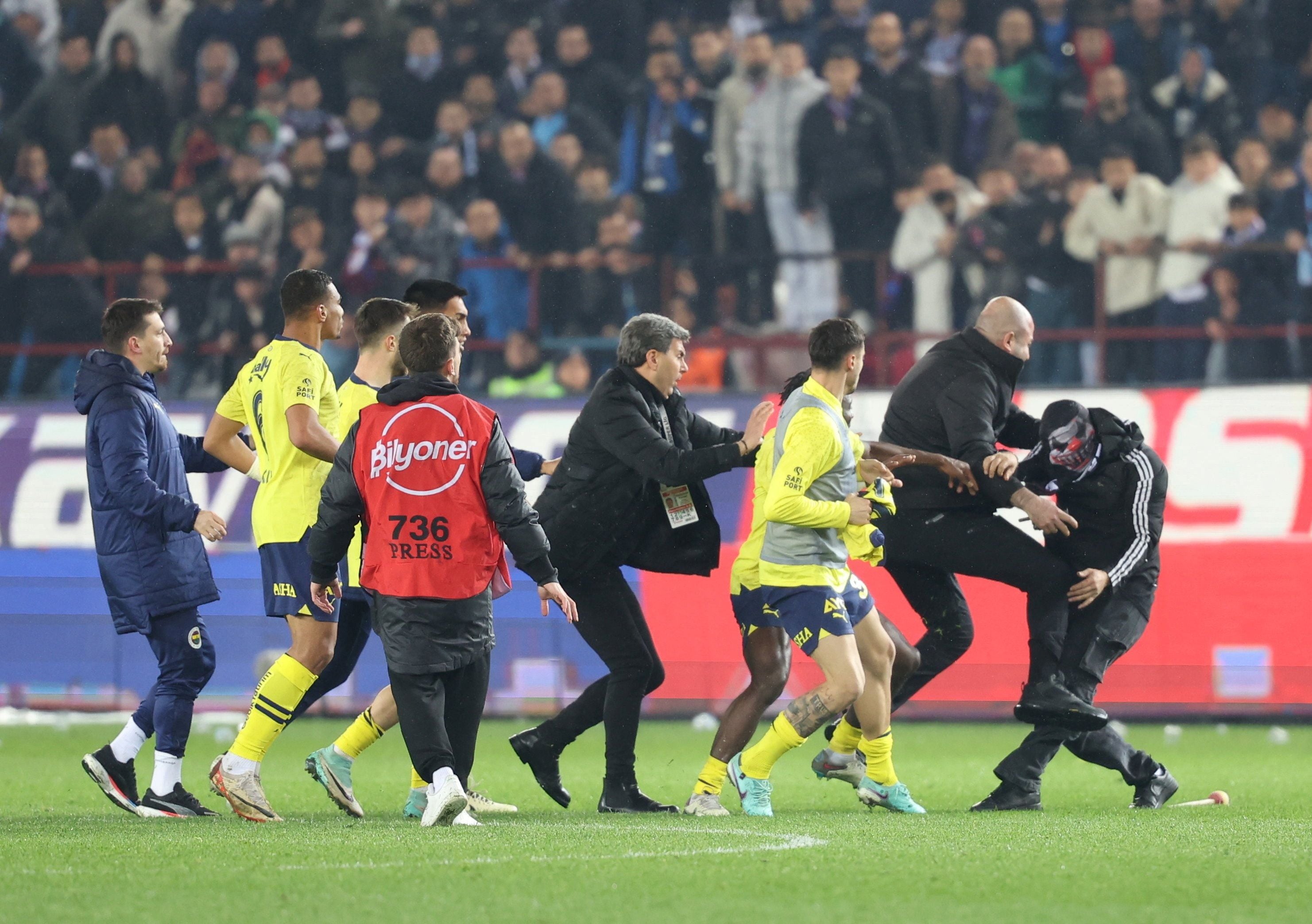 El primer aficionado del Trabzonspor que ingresó al campo de juego se llevó la respuesta de los jugadores del Fenerbahce