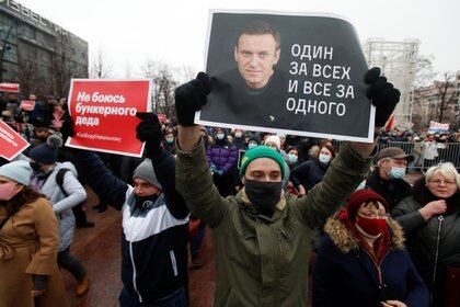 A participant holds a placard reading "One for all, all for one" during a rally in support of jailed Russian opposition leader Alexei Navalny in Moscow, Russia January 23, 2021. REUTERS/Maxim Shemetov