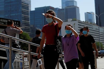 Personas usan mascarillas mientras se dirigen al trabajo durante la hora punta de la mañana, después de los nuevos casos de infecciones de la enfermedad coronavirus (COVID-19) en Pekín, China, el 15 de junio de 2020. REUTERS/Thomas Peter