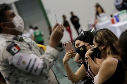 Un trabajador de una escuela toma una foto después de recibir una dosis de la vacuna CanSino COVID-19 de China durante una vacunación masiva contra la enfermedad por coronavirus en la Universidad Autónoma de Nuevo León en San Nicolás de los Garza, en las afueras de Monterrey, México, el 27 de abril de 2021. REUTERS / Daniel Becerril/ Foto de archivo