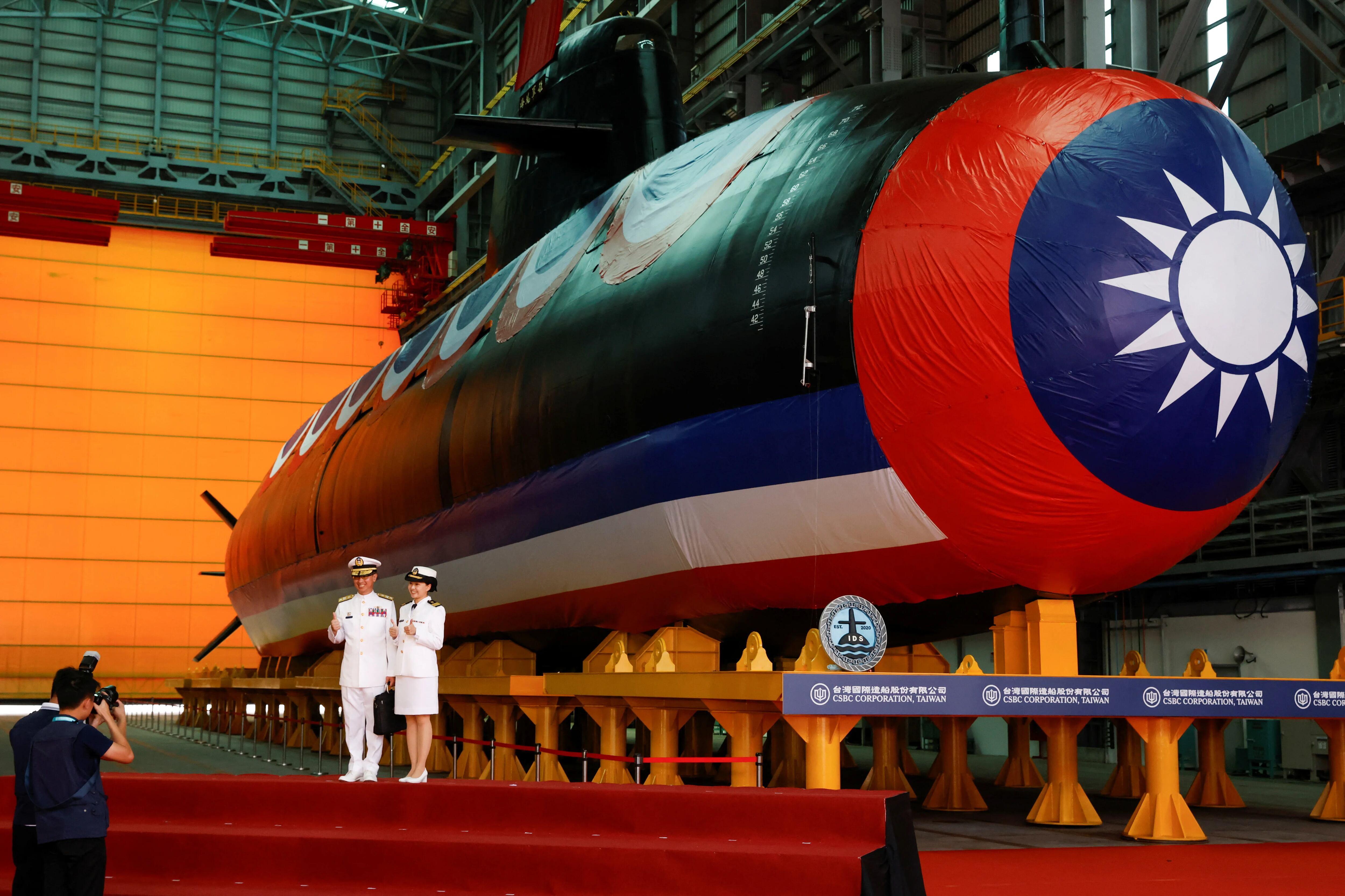 Members of the navy pose for pictures next to Haikun, Taiwan's first domestically built submarine, after its launching ceremony in Kaohsiung, Taiwan September 28, 2023. REUTERS/Carlos Garcia Rawlins