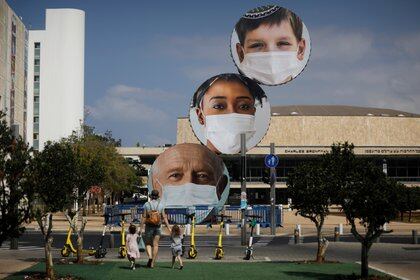 A sculpture decorated with images of people wearing protective face masks is seen at Habima Square, as Israeli Prime Minister Benjamin Netanyahu's cabinet decided on Thursday to tighten Israel's second nationwide coronavirus disease (COVID-19) lockdown, in Tel Aviv, Israel September 24, 2020. REUTERS/Nir Elias