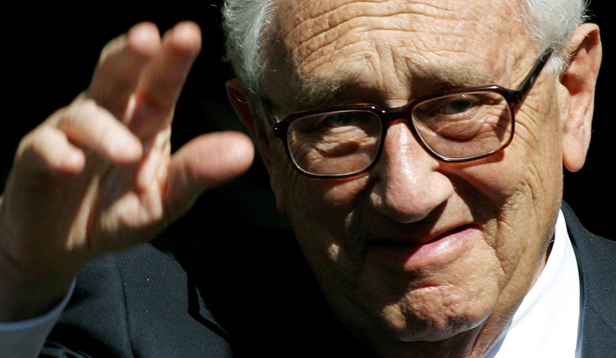 FILE PHOTO: Former U.S Secretary of State Dr Henry Kissinger waves to the media as he leaves the Royal Albert Hall in London, Britain April 24, 2002. REUTERS/Kieran Doherty/File Photo
