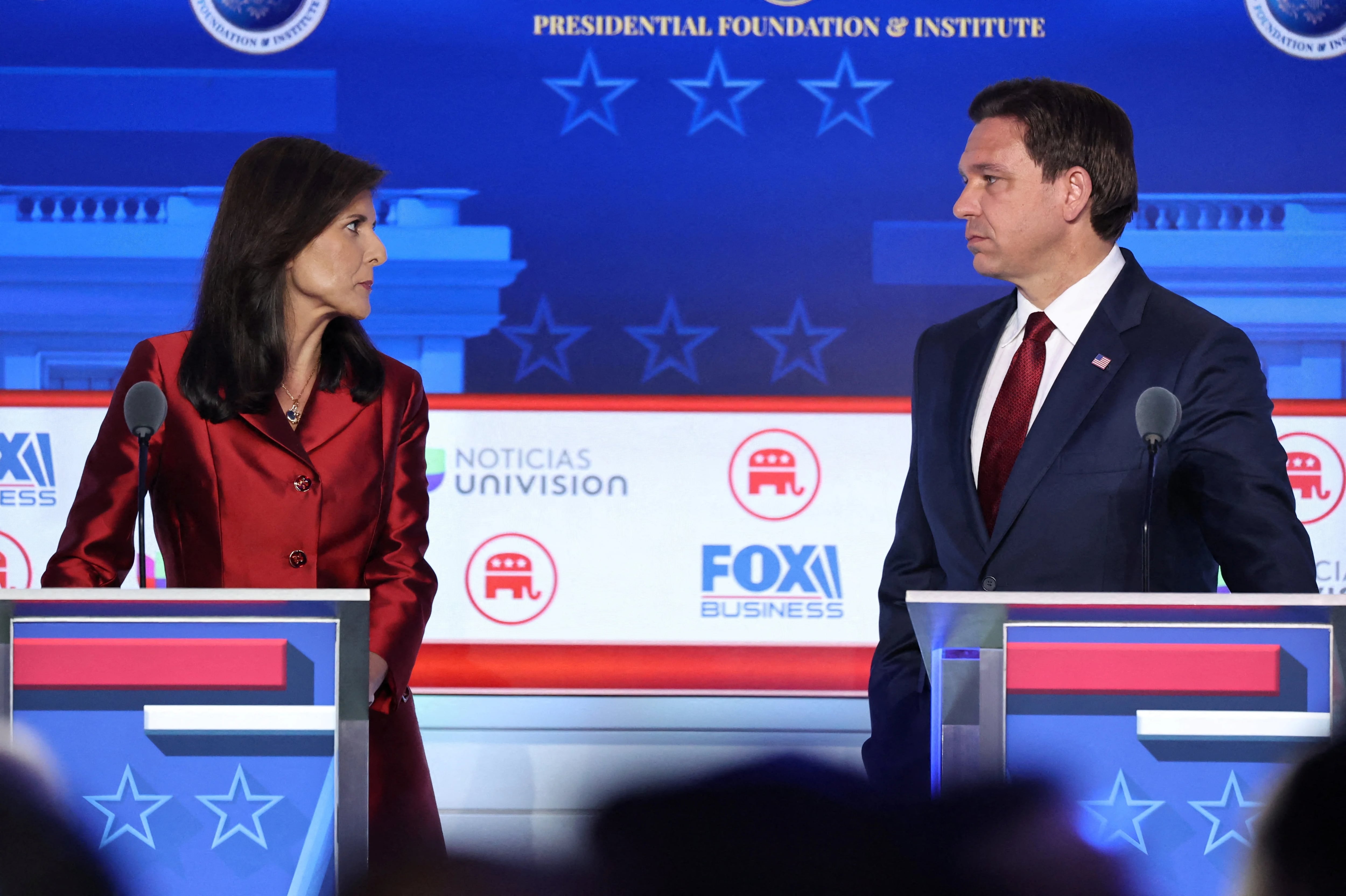 Former South Carolina Governor Nikki Haley and Florida Governor Ron DeSantis look over at each other during the second Republican candidates' debate of the 2024 U.S. presidential campaign at the Ronald Reagan Presidential Library in Simi Valley, California, U.S. September 27, 2023. REUTERS/Mike Blake     TPX IMAGES OF THE DAY