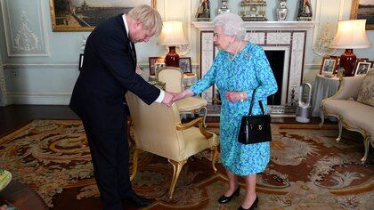 FILE PHOTO: Queen Elizabeth II welcomes Boris Johnson during an audience in Buckingham Palace, where she officially recognised him as the new Prime Minister, in London, Britain July 24, 2019. Victoria Jones/Pool via REUTERS/File Photo