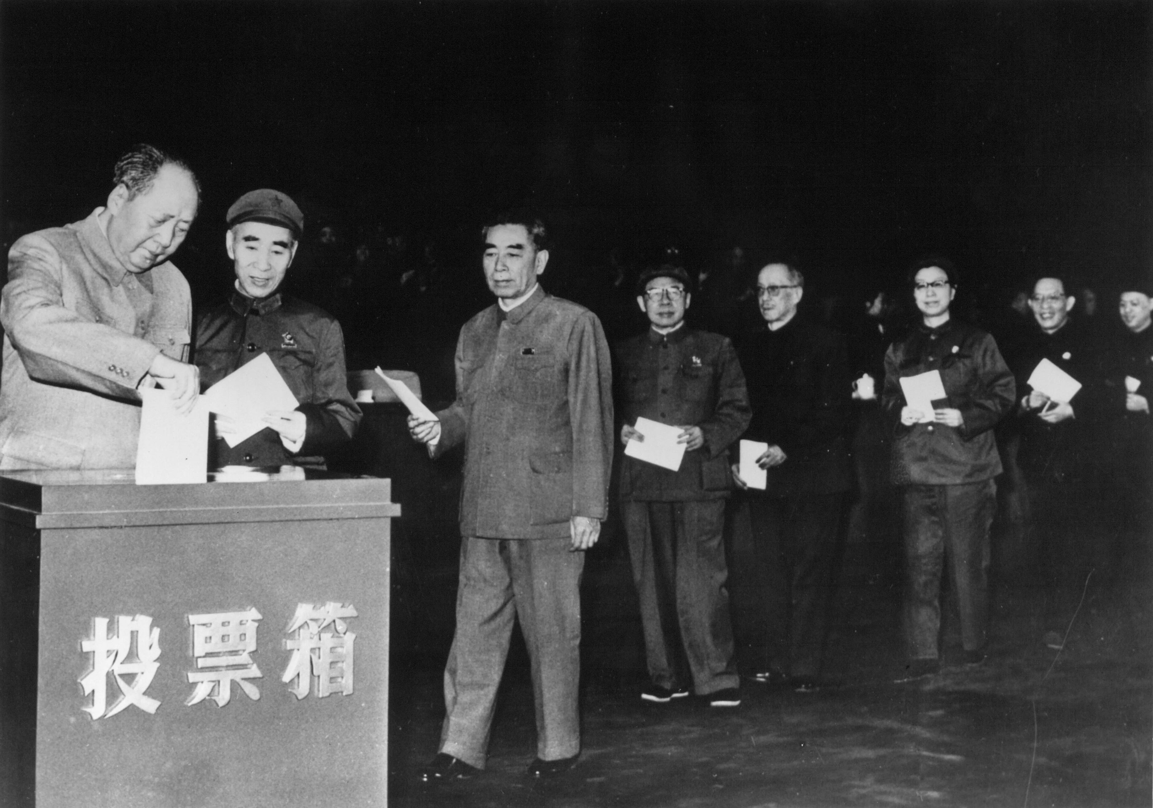 29 de abril de 1969:  A la izquierda, el presidente Mao Zedong (1893 - 1976) deposita su voto en el noveno congreso nacional comunista de China en Pekín. Esperando para depositar su voto en orden jerárquico, desde la 2ª izquierda, Lin Piao, Chou En-Lai, Chen Po_Tak, Kang Sheng, Chiang Ching (esposa de Mao), Chang Chun-Chiao y Yao Wen-Yuan (Foto Getty Images)