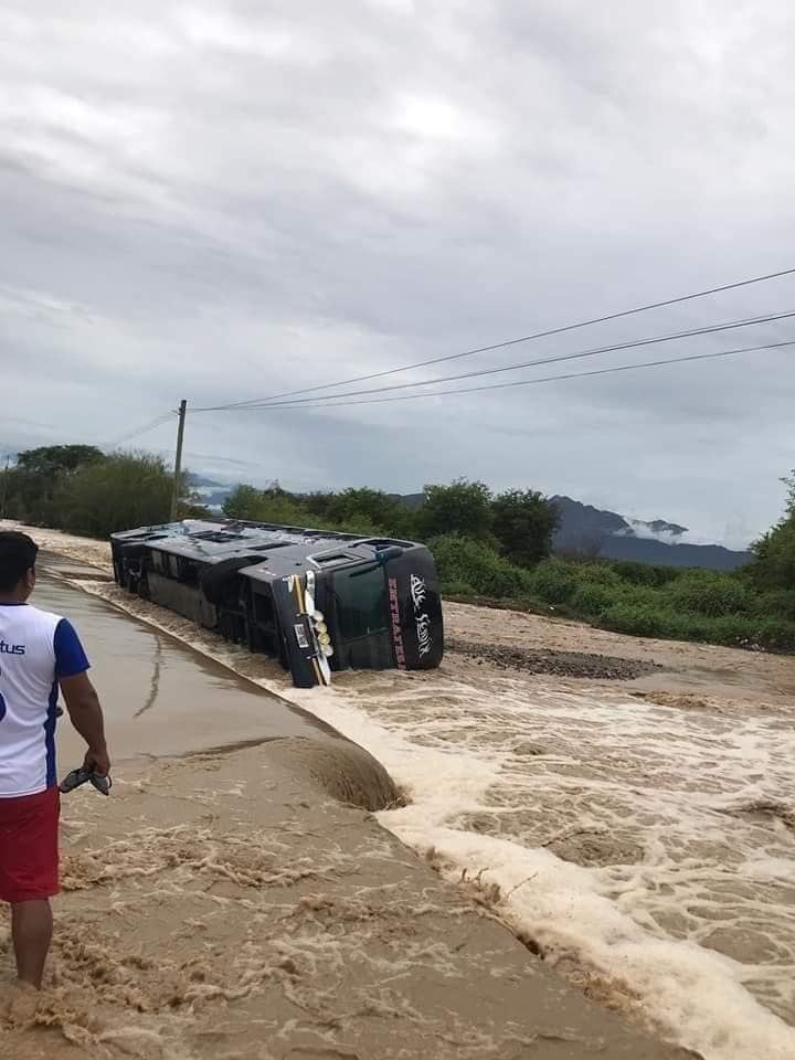 Bus tries to cross the river and flips over.