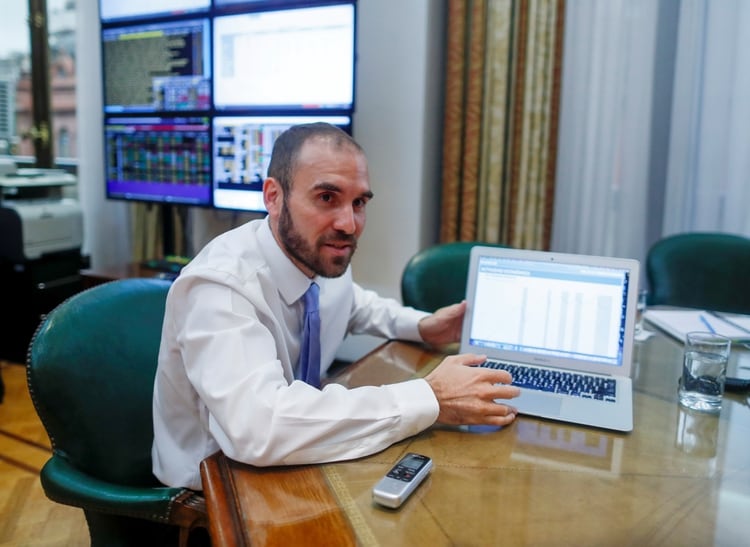 Argentine Economy Minister Martin Guzman shows a graphic during an interview with Reuters, in Buenos Aires, Argentina March 11, 2020. Picture taken March 11, 2020. REUTERS/Agustin Marcarian