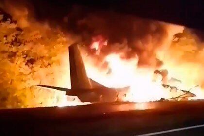 In this TV grab released by Ukraine's Emergency Situation Ministry, an AN-26 military plane bursts into flames after it crashed in the town of Chuguyiv close to Kharkiv, Ukraine, late Friday, Sept. 25, 2020. Among 28 people on board 22 people were killed. (Emergency Situation Ministry via AP)