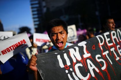 A student reacts as family members gather to mark the 74th month since the disappearance of the 43 students of the Ayotzinapa College "Raul Isidro Burgos" in the state of Guerrero, in Mexico City, Mexico, November 26, 2020. REUTERS/Edgard Garrido