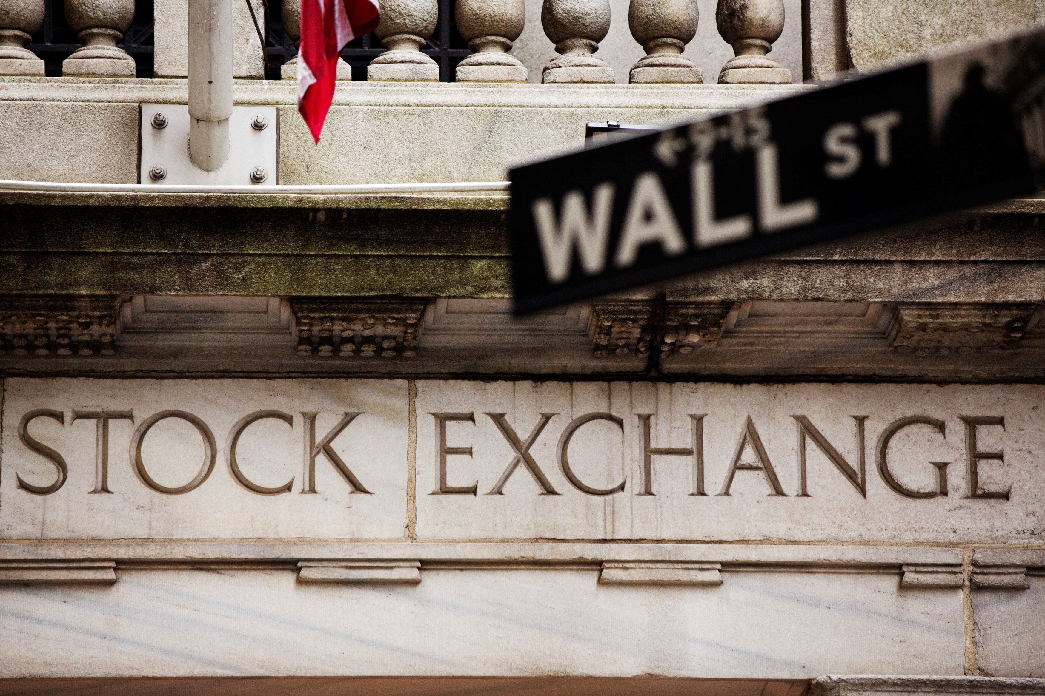 FILE PHOTO: A street sign for Wall Street hangs in front of the New York Stock Exchange May 8, 2013. REUTERS/Lucas Jackson/File Photo