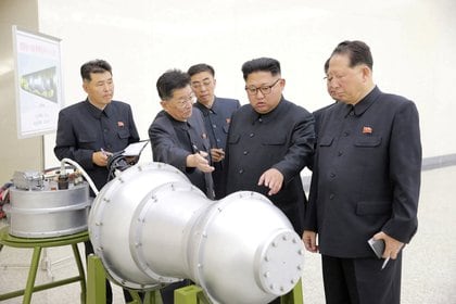 FILE PHOTO: North Korean leader Kim Jong Un provides guidance with Ri Hong Sop (2nd L) and Hong Sung Mu (R) on a nuclear weapons programme in this undated photo released by North Korea's Korean Central News Agency (KCNA) in Pyongyang September 3, 2017.  KCNA via REUTERS/File Photo    ATTENTION EDITORS - THIS PICTURE WAS PROVIDED BY A THIRD PARTY. REUTERS IS UNABLE TO INDEPENDENTLY VERIFY THIS IMAGE. NO THIRD PARTY SALES. SOUTH KOREA OUT.