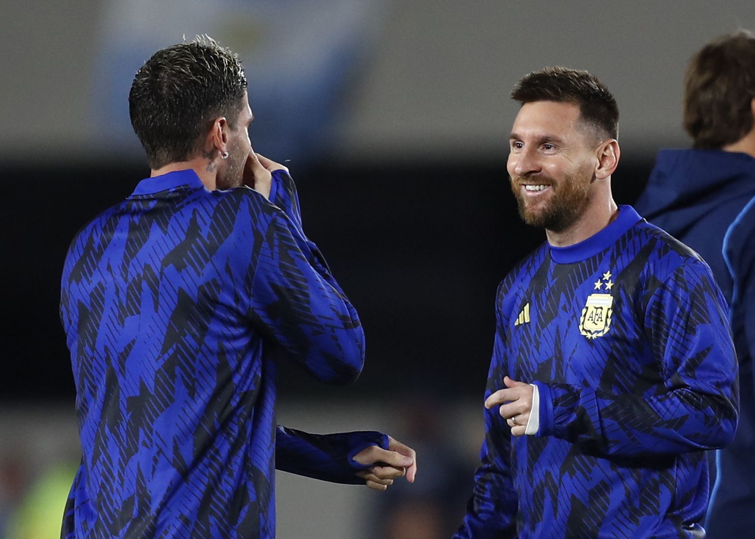 Lionel Messi dialoga con Rodrigo De Paul en la entrada en calor. El astro será suplente ante Paraguay (REUTERS/Agustin Marcarian)