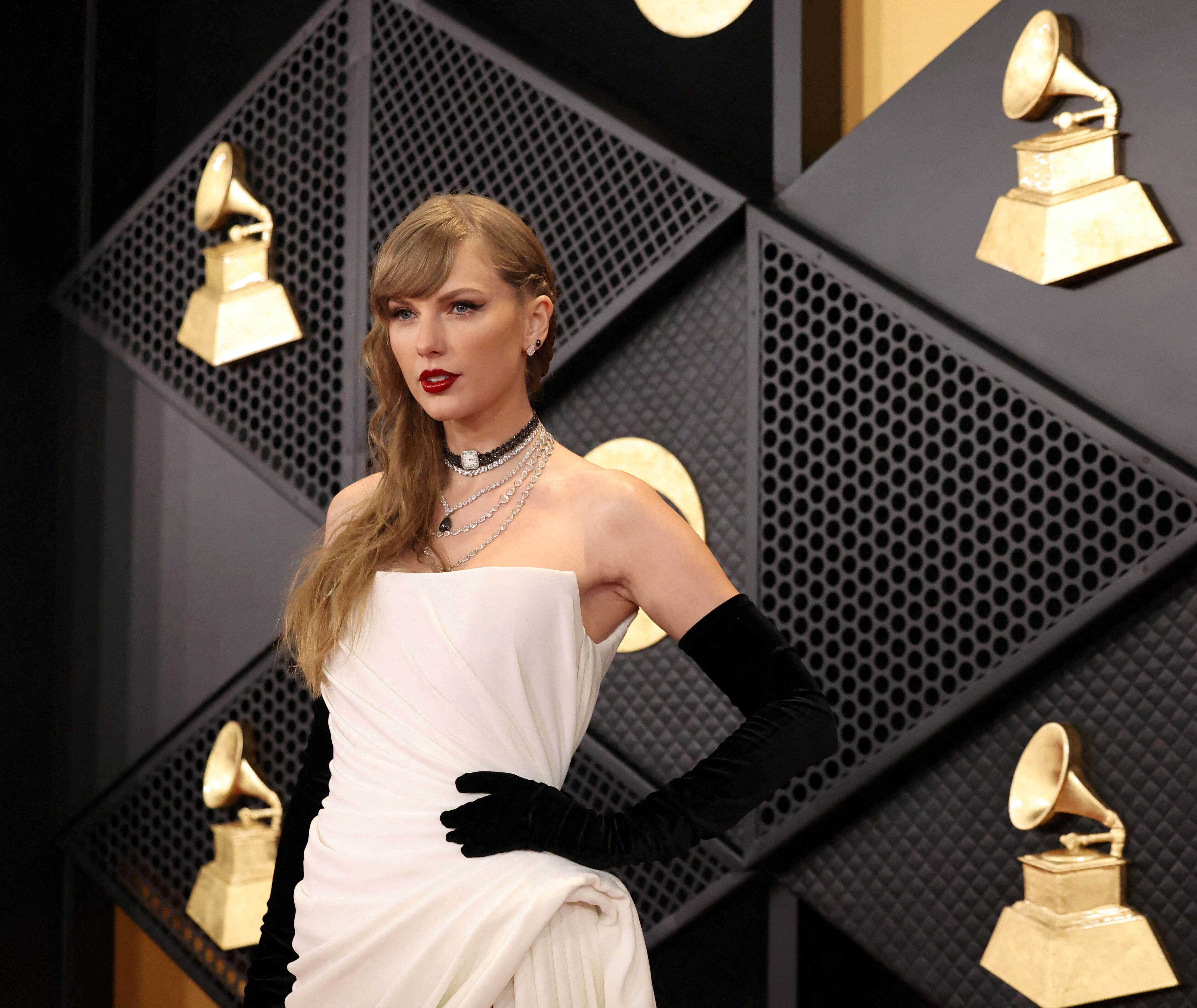 FILE PHOTO: Taylor Swift poses on the red carpet as she attends the 66th Annual Grammy Awards in Los Angeles, California, U.S., February 4, 2024.  REUTERS/Mario Anzuoni/File Photo