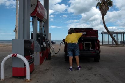 Una cliente carga combustible como parte de los preparativos para el huracán (AFP)