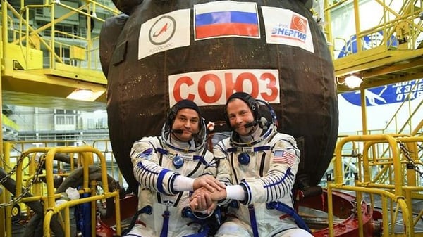 Los astronautas posan con la cápsula que les salvó la vida en su regreso hoy a la Tierra