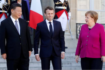 French President Emmanuel Macron, German Chancellor Angela Merkel and Chinese President Xi Jinping retire through a meeting at the Palace of Eliseo in Paris, France, March 26, 2019 (REUTERS / Philippe Wojazer)