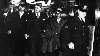 Alphonse Capone es escoltado por agentes federales luego de ser condenado por evasión impositiva en los tribunales de Chicago (Shutterstock) 