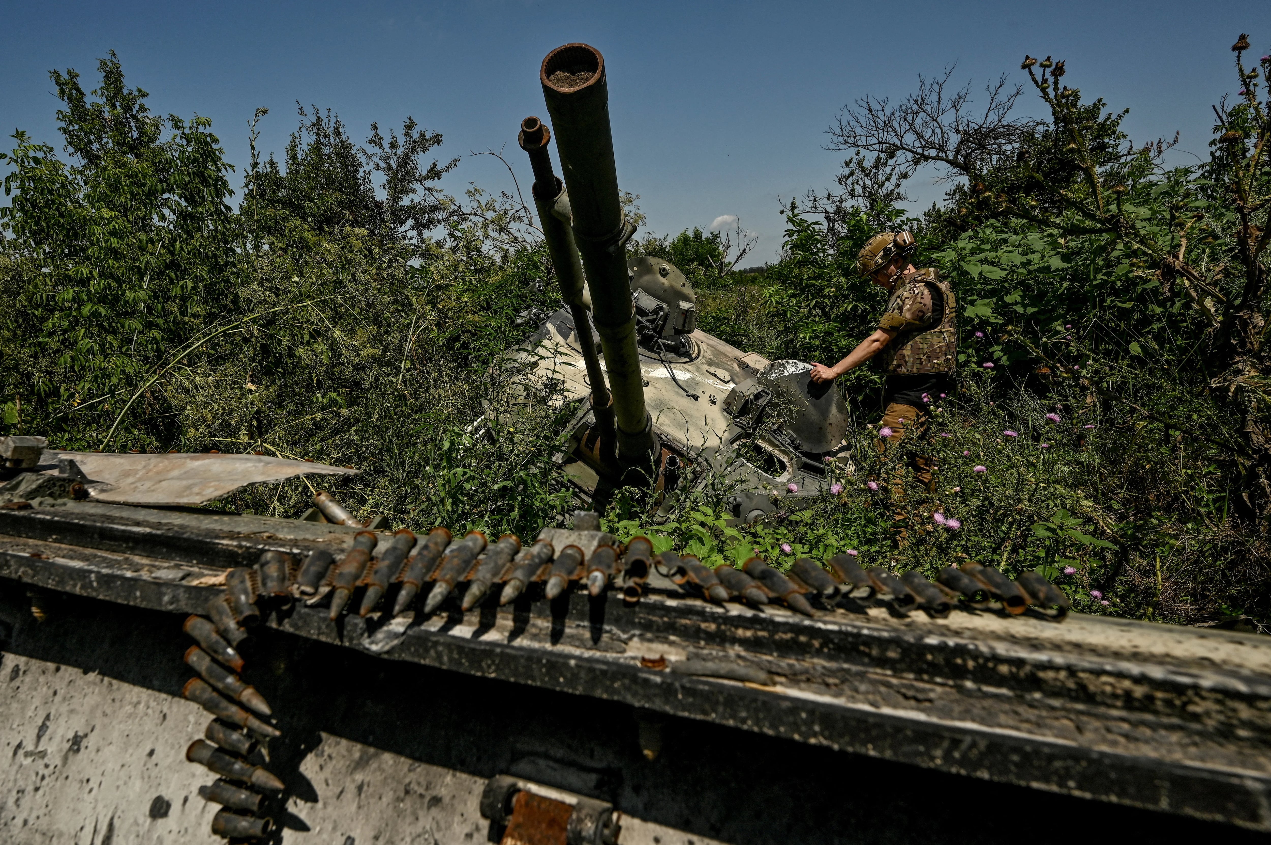 FILE PHOTO: Ukrainian serviceman inspects a turret of a destroyed Russian BMP-3 infantry fighting vehicle in the village of Novodarivka, Ukraine