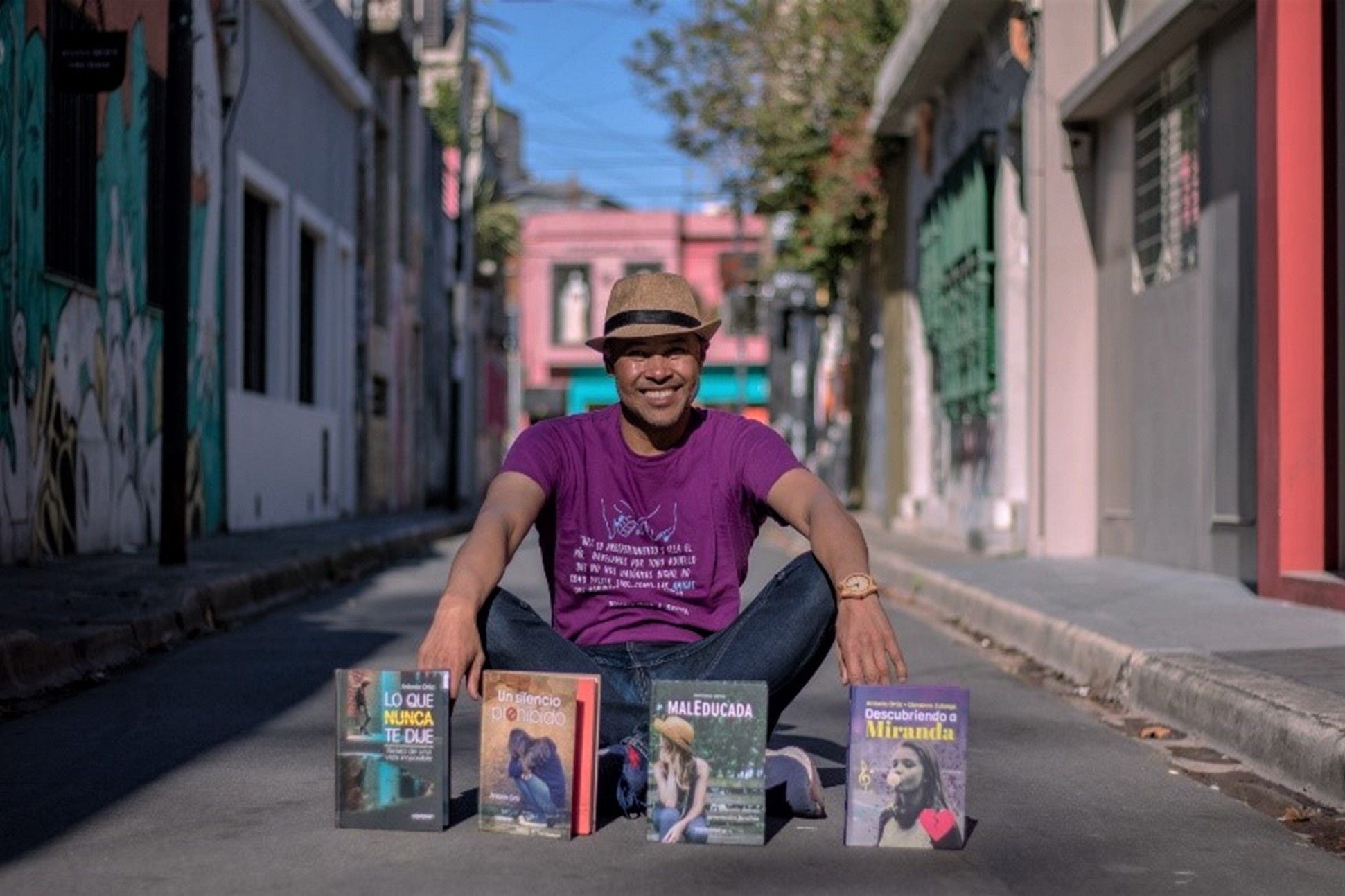 Colombian writer Antonio Ortiz poses with some of his works