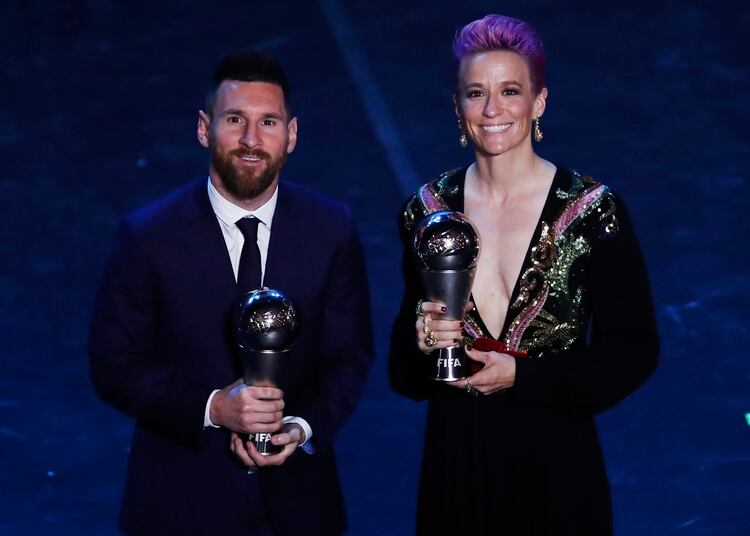 Argentinian Barcelona player Lionel Messi poses with United States forward Megan Rapinoe after they received the Best FIFA Men's, Women's player award during the Best FIFA soccer awards ceremony, in Milan's La Scala theater, northern Italy, Monday, Sept. 23, 2019. (AP Photo/Antonio Calanni)