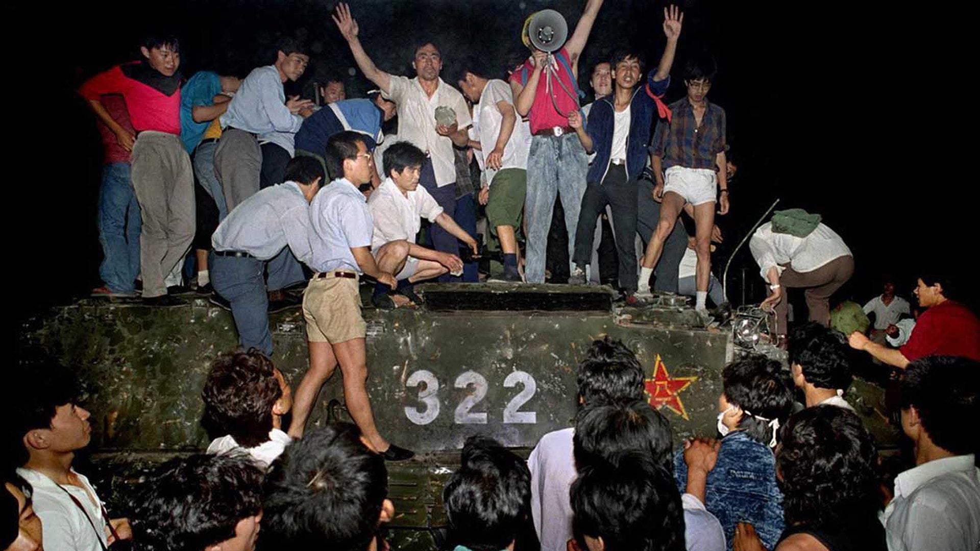 Un grupo de jóvenes sobre un tanque cerca de la plaza Tiananmén