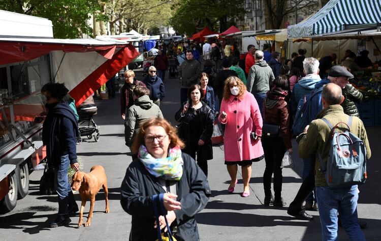 La gente pasa por los puestos de los comerciantes en un mercado semanal en Berlín, Alemania, el 25 de abril de 2020. (REUTERS/Annegret Hilse)