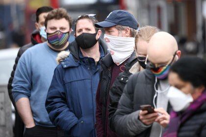 People queue for a COVID-19 swab test, after a new SARS-CoV-2 coronavirus variant originating from South Africa was discovered, in Ealing, West London, Britain February 2, 2021. REUTERS/Henry Nicholls