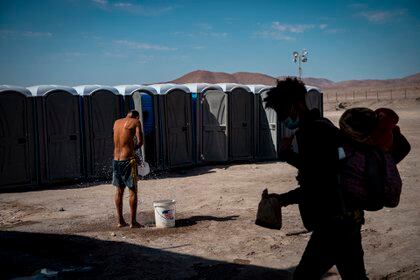 Un migrante venezolano se refresca (MARTIN BERNETTI / AFP)