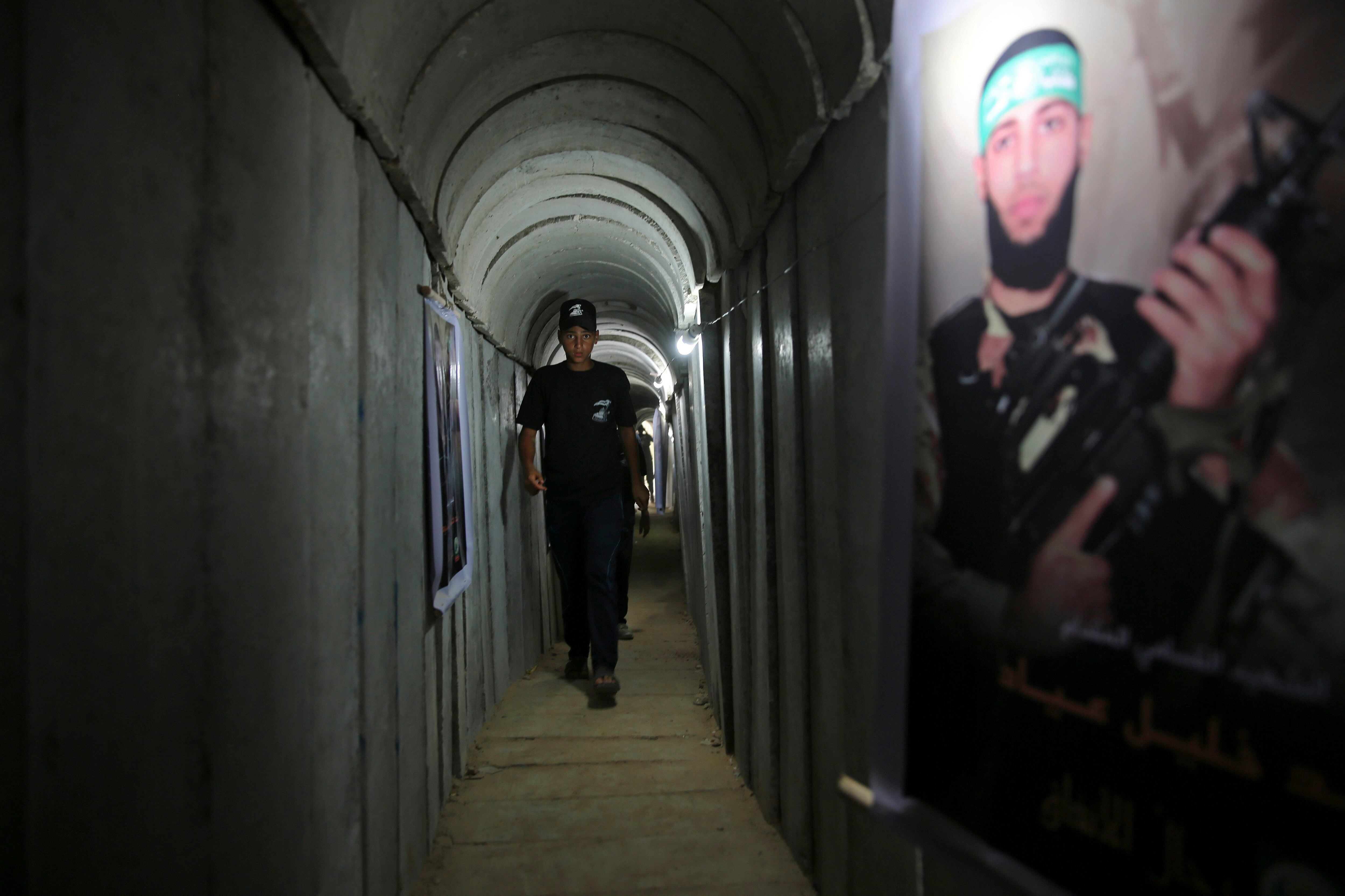 FILE - A Palestinian youth walks inside a tunnel used for military exercises during a weapon exhibition at a Hamas-run youth summer camp in Gaza City July 20, 2016. An extensive labyrinth of tunnels built by Hamas stretches across the dense neighborhoods of the Gaza Strip, hiding militants, their missile arsenal and the over 200 hostages they now hold after an unprecedented Oct. 7, 2023, attack on Israel. (AP Photo/Adel Hana, File)