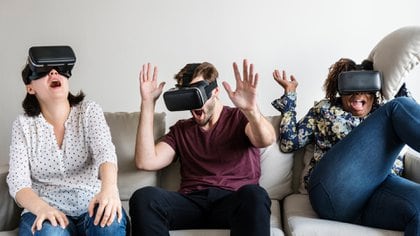 Virtual Reality. Happy Spouses Using VR Goggles Playing Videogame Sitting On Floor At Home. Selective Focus