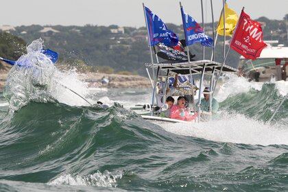 Un bote con banderas a favor de Trump es golpeado por las olas (Reuters)