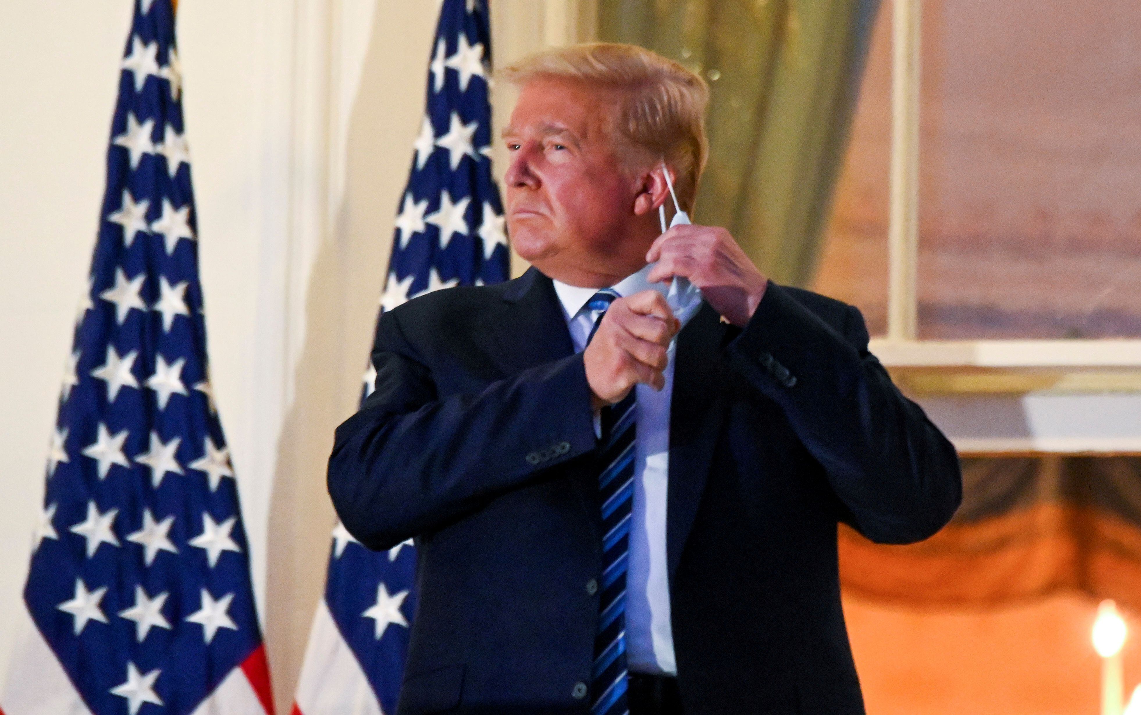 En octubre del 2020, Donald Trump se paró en el balcón del Pórtico Sur de la Casa Blanca y, en un gesto teatral, se quitó la máscara cuando aún estaba contagioso con el virus del COVID-19 (Foto: REUTERS)