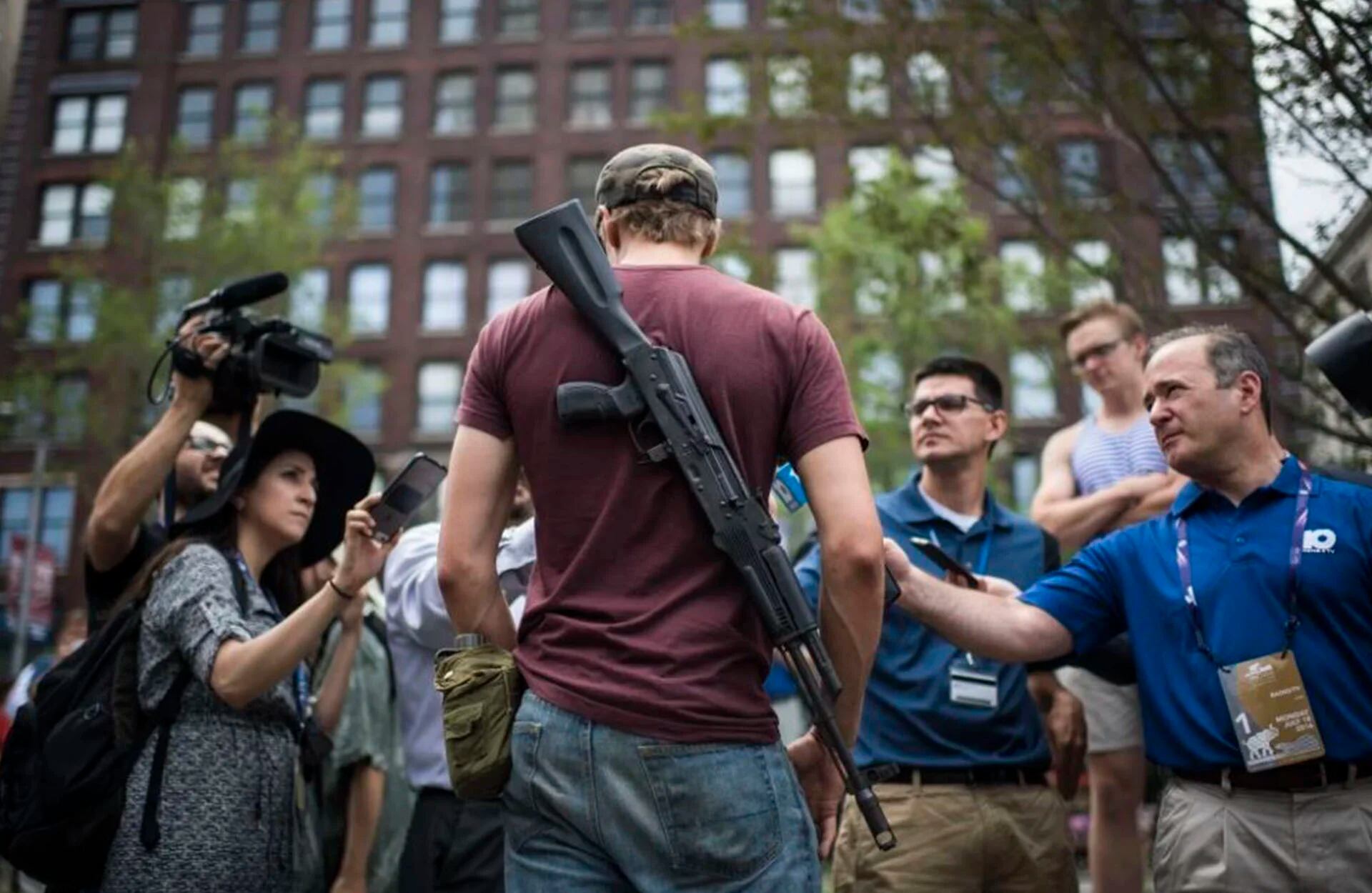 Un manifestante pro-Trump con un rifle conversa con la prensa sobre la libre portación de armas en las afueras del estadio donde se desarrolla la Convención Republicana, en Cleveland (The Washington Post)