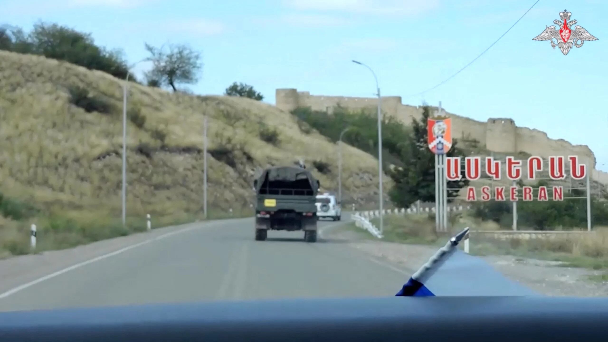 Russian peacekeepers drive vehicles to evacuate civilians in the town of Askeran following the launch of a military operation by Azerbaijani forces in the region of Nagorno-Karabakh, a region inhabited by ethnic Armenians, in this still image from video published September 20, 2023. Russian Defence Ministry/Handout via REUTERS ATTENTION EDITORS - THIS IMAGE WAS PROVIDED BY A THIRD PARTY. NO RESALES. NO ARCHIVES. MANDATORY CREDIT. WATERMARK FROM SOURCE.