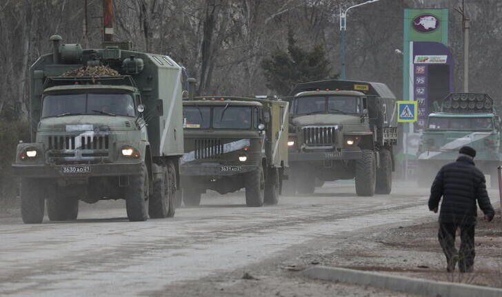 Vehículos militares rusos pasan por una calle después de que el presidente Vladimir Putin autorizó una operación militar en el este de Ucrania (REUTERS)