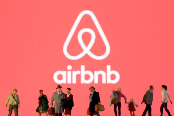 FILE PHOTO: Small toy figures are seen in front of diplayed Airbnb logo in this illustration taken March 19, 2020. REUTERS/Dado Ruvic/Illustration/File Photo