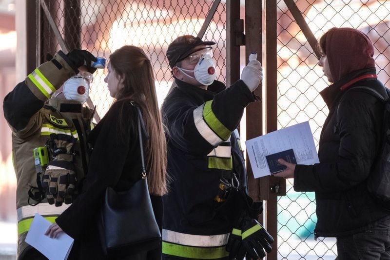 Las autoridades polacas toman la temperatura corporal de los pasajeros, que llegaron en tren desde Ucrania, como medida preventiva contra el coronavirus (COVID-19) en una estación de ferrocarril en Przemysl, Polonia. 10 de marzo de 2020. Imagen proporcionada por un tercero. Patryk Ogorzalek/Agencja Gazeta vía REUTERS.