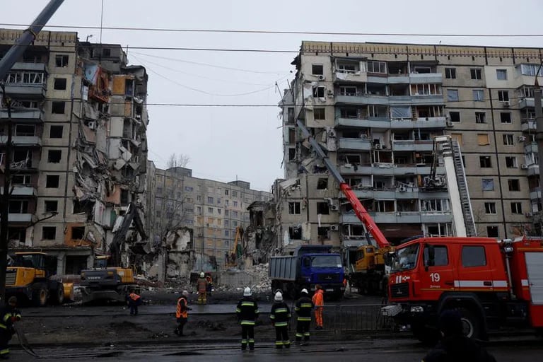Personal de emergencia trabaja en el lugar donde un bloque de apartamentos resultó gravemente dañado por un ataque con m 