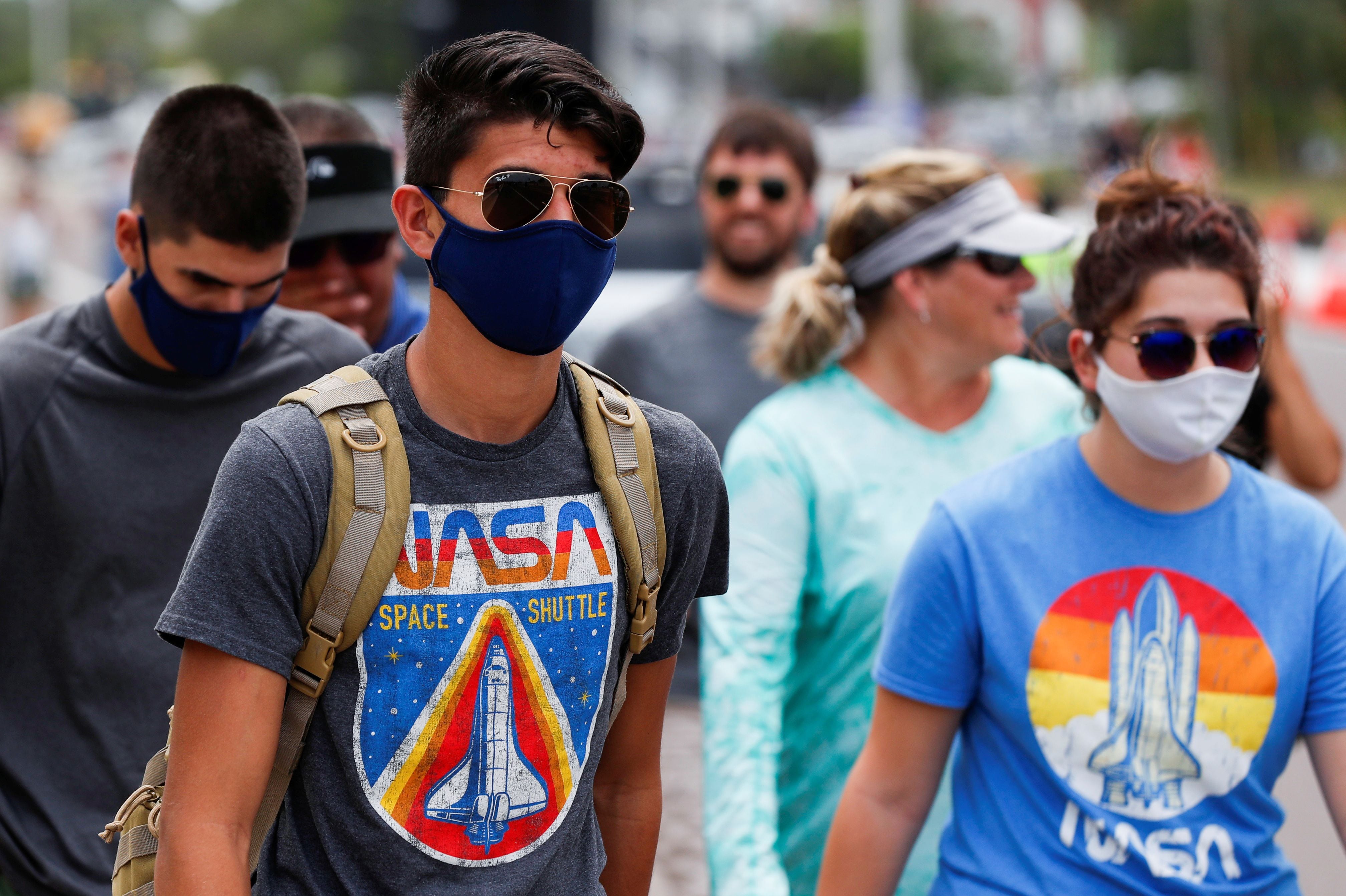 People wearing NASA'S T-shirts attend to watch the launching of a SpaceX Falcon 9 rocket and Crew Dragon spacecraft carrying NASA's astronauts Douglas Hurley and Robert Behnken during NASA's SpaceX Demo-2 mission to the International Space Station from NASA's Kennedy Space Center, in Cape Canaveral, Florida, U.S. May 30, 2020. REUTERS/Scott Audette