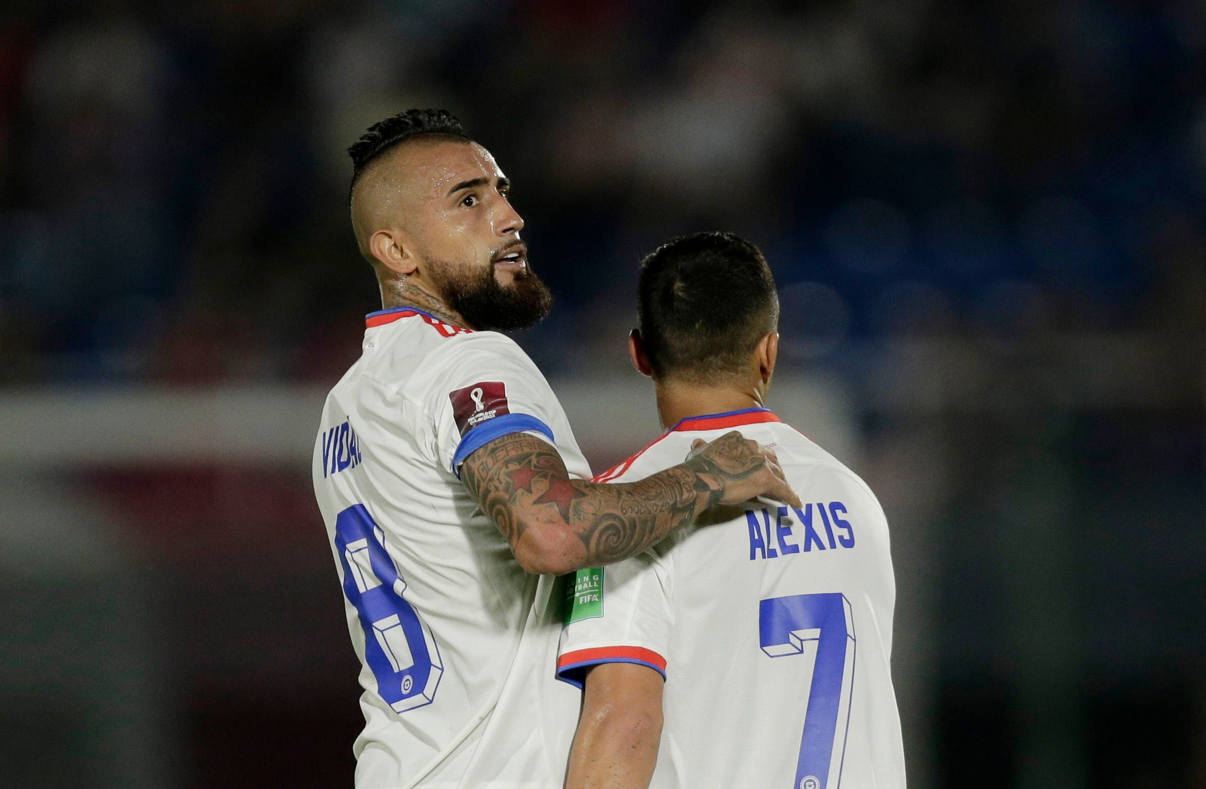 Soccer Football - World Cup - South American Qualifiers - Paraguay v Chile - Defensores del Chaco, Asuncion, Paraguay - November 11, 2021 Chile's Arturo Vidal and Alexis Sanchez celebrates after Paraguay's Antony Silva scored an own goal and their first goal REUTERS/Cesar Olmedo