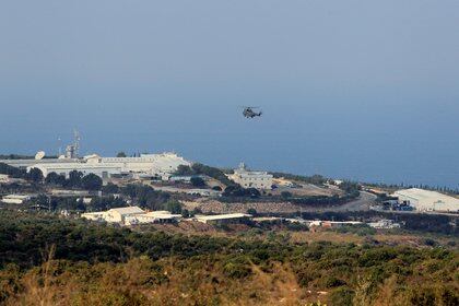 An aircraft flies over a base for U.N. peacekeepers of the United Nations Interim Force in Lebanon (UNIFIL) in Naqoura, near the Lebanese-Israeli border, southern Lebanon October 29, 2020. REUTERS/Aziz Taher