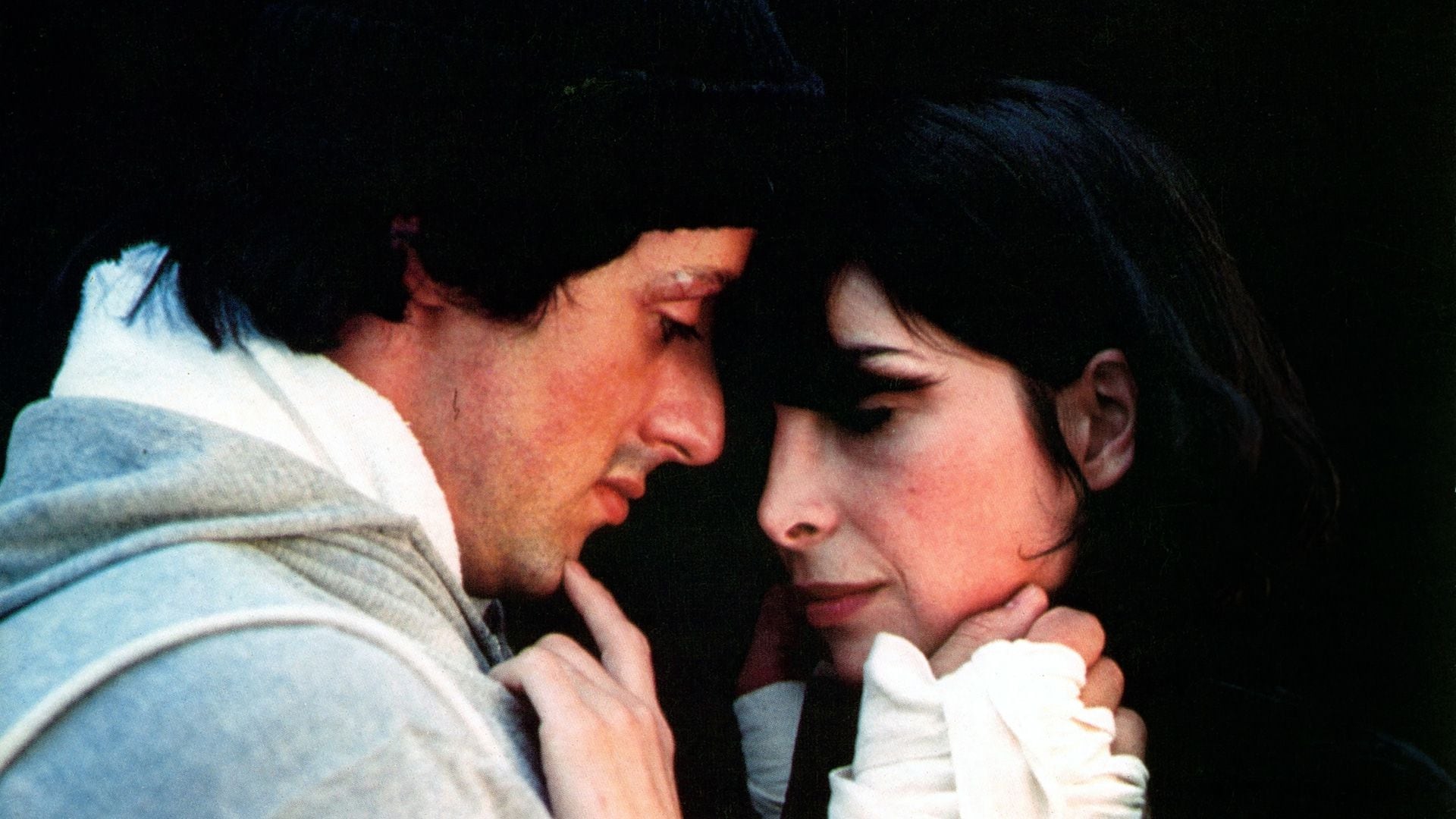 Sylvester Stallone sharing romantic moment with Talia Shire in a scene from the film 'Rocky', 1976. (Photo by United Artists/Getty Images)