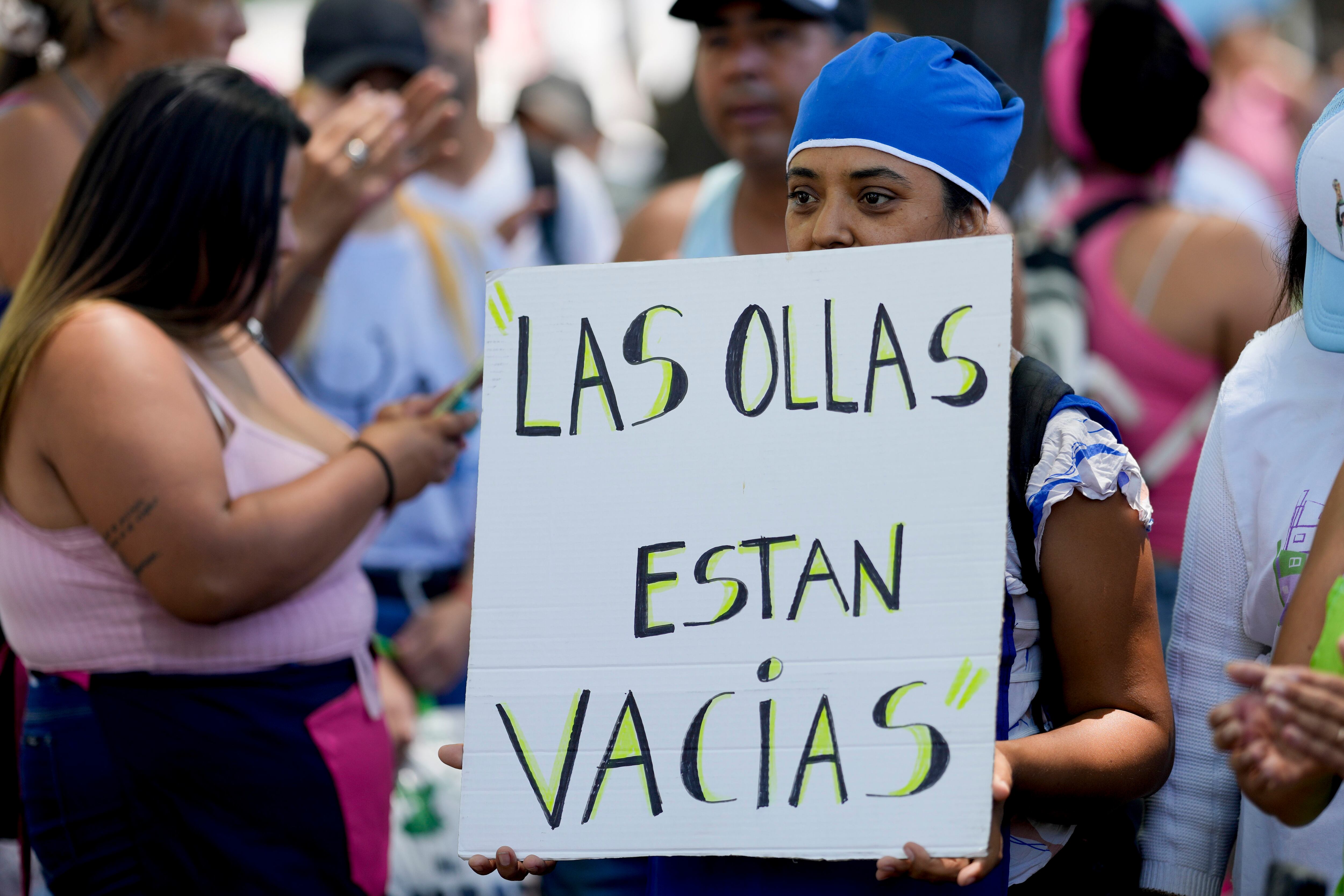 Un manifestante sostiene un cartel que dice "Las ollas están vacías" durante una manifestación contra las reformas económicas del gobierno frente a la residencia presidencial de Olivos en Buenos Aires, Argentina, el martes 23 de enero de 2024. (AP Foto/Natacha Pisarenko)