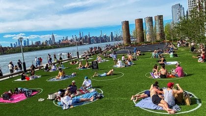 FILE PHOTO: People try to keep social distance as they enjoy a warm day during the outbreak of the coronavirus disease (COVID-19) at Domino Park in Brooklyn, New York, U.S., May 16, 2020. REUTERS/Eduardo Munoz/File Photo