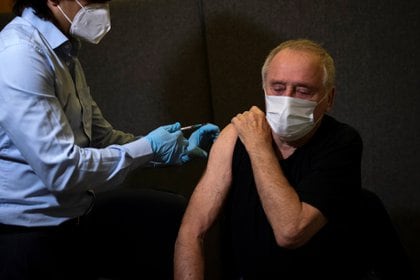 Un hombre recibe la primera de las dos inyecciones de la vacuna Pfizer-BioNTech COVID-19 en la Clínica Hurley en Londres, Gran Bretaña, el 14 de diciembre de 2020. Aaron Chown / PA Wire / Pool vía REUTERS