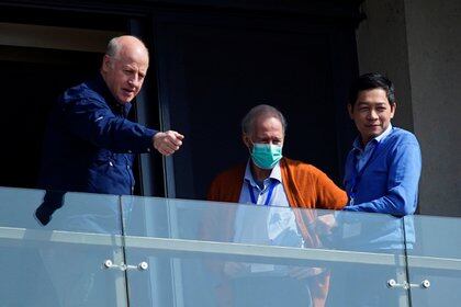 Peter Daszak (L) and Hung Nguyen-Viet (R), members of the World Health Organisation (WHO) team tasked with investigating the origins of the coronavirus disease (COVID-19), stand on the balcony of their hotel in Wuhan, Hubei province, China February 6, 2021. REUTERS/Aly Song